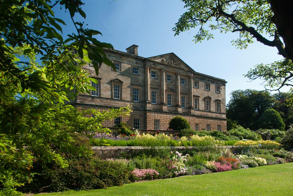 alt="Front of Howick Hall with gardens"