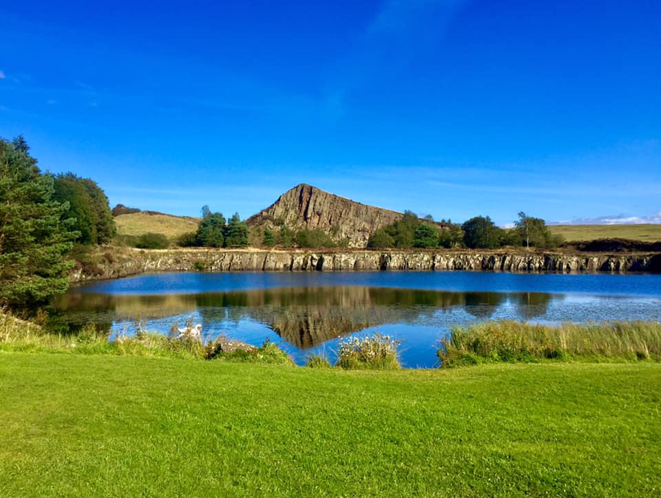 alt="Cawfield Quarry with blue skies above"